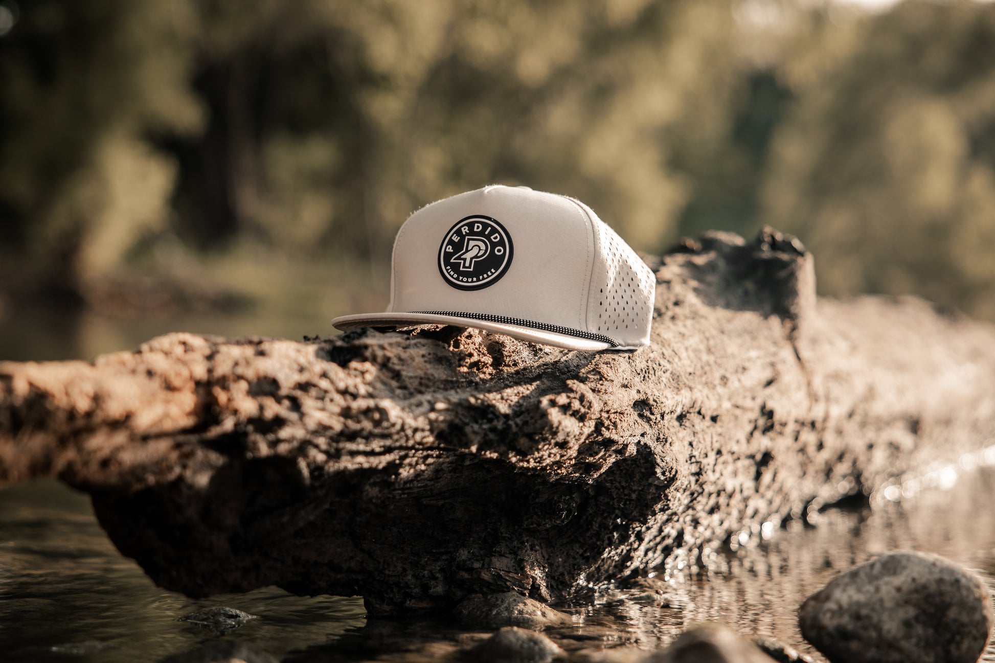 Khaki water resistant five panel snapback with black and white rubber perdido patch
